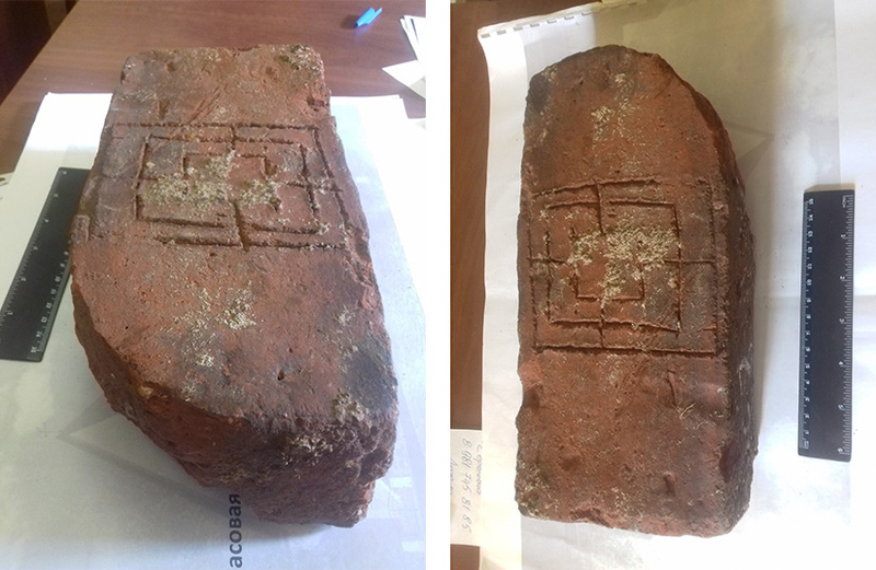 The clay tablet with a game board etched onto it.